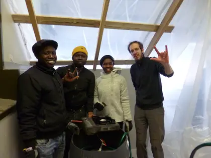 Students from Ghana and Dominik Jais showing an modified gas stove